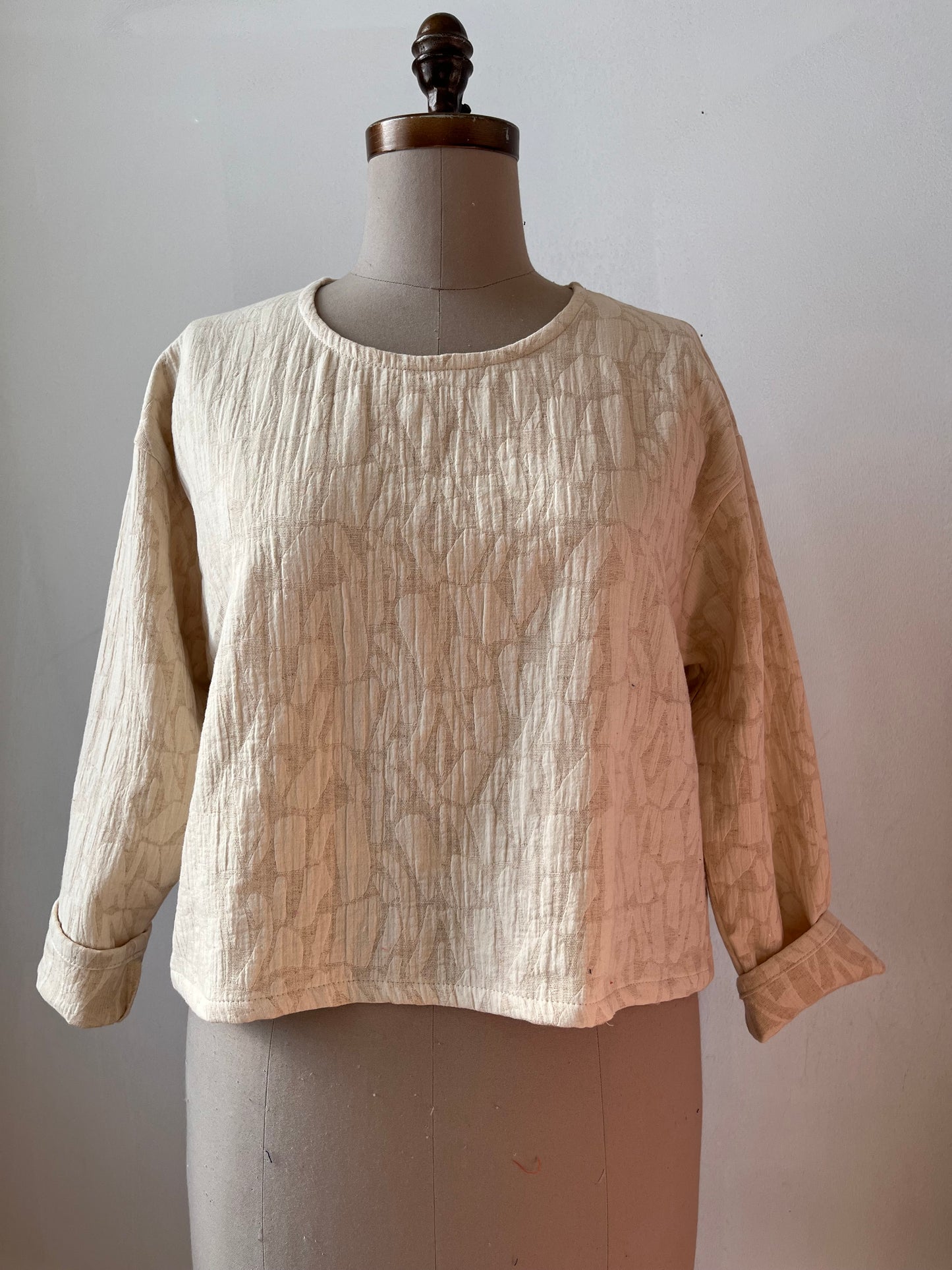 Cream textured long sleeve top