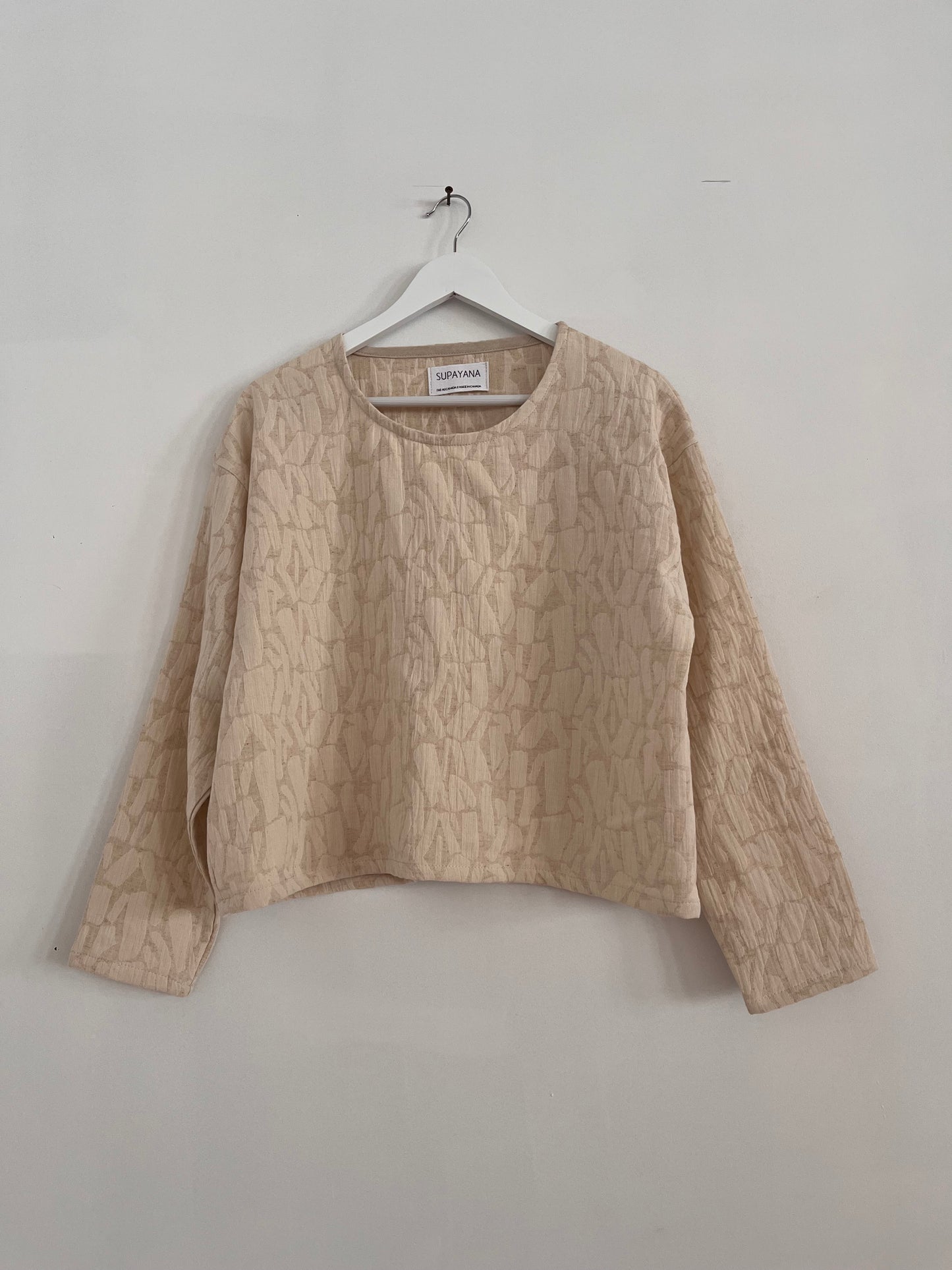 Cream textured long sleeve top